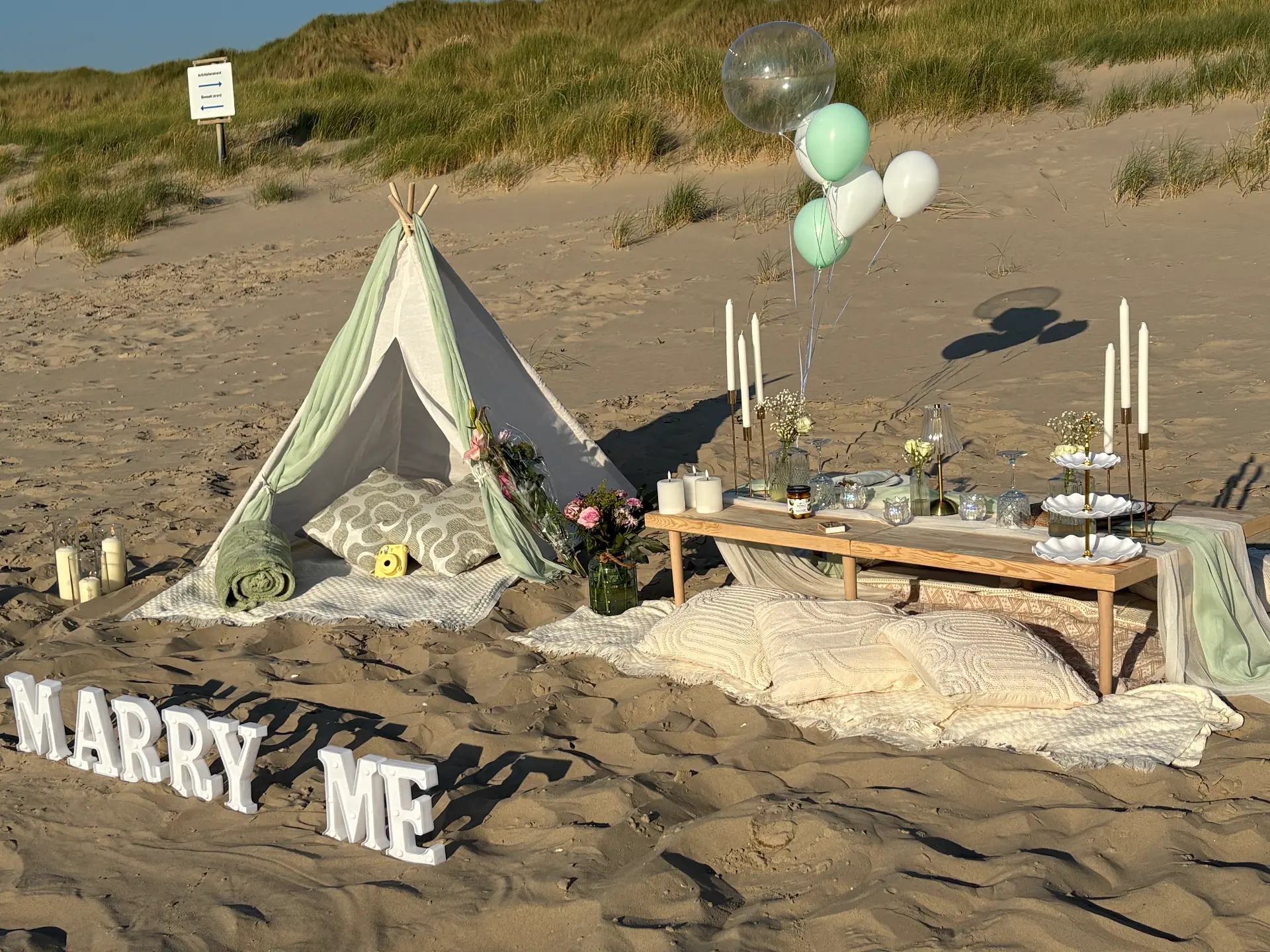 Romantic Mini Munchkins beach picnic with a teepee and proposal styling
