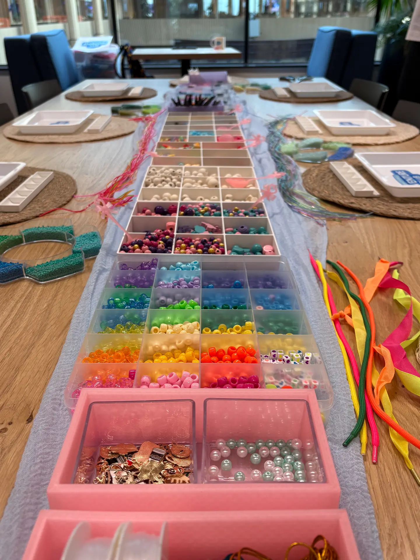 A bracelet bar laid out with colourful beads and charms at a Mini Munchkins workshop