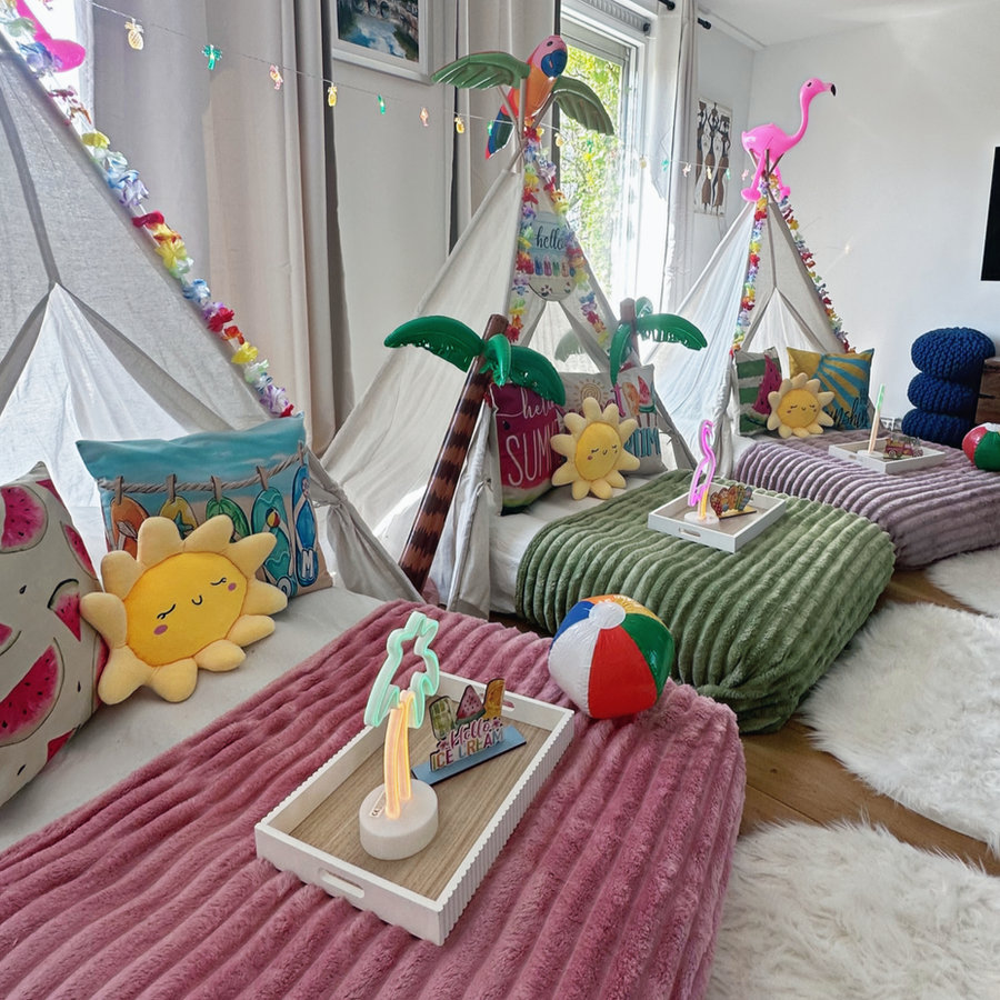 Teepees with bedding, fairy lights and lanterns