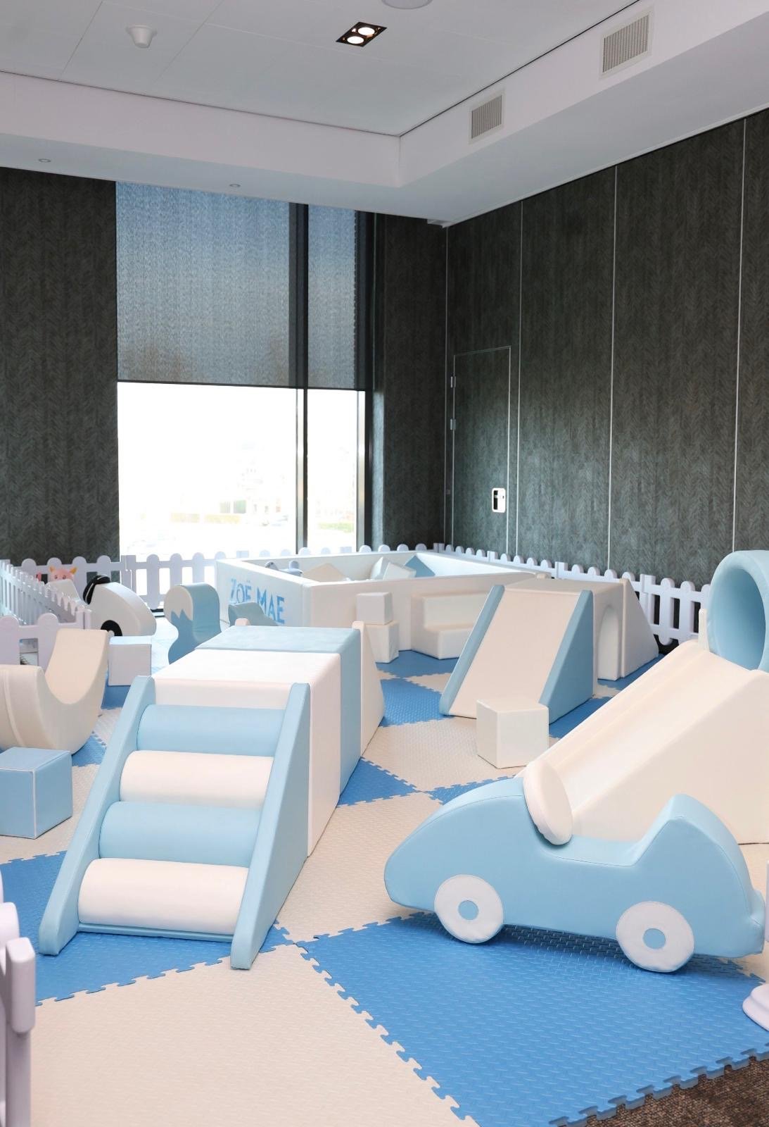 Blue and white Mini Munchkins soft play shapes arranged in an event room