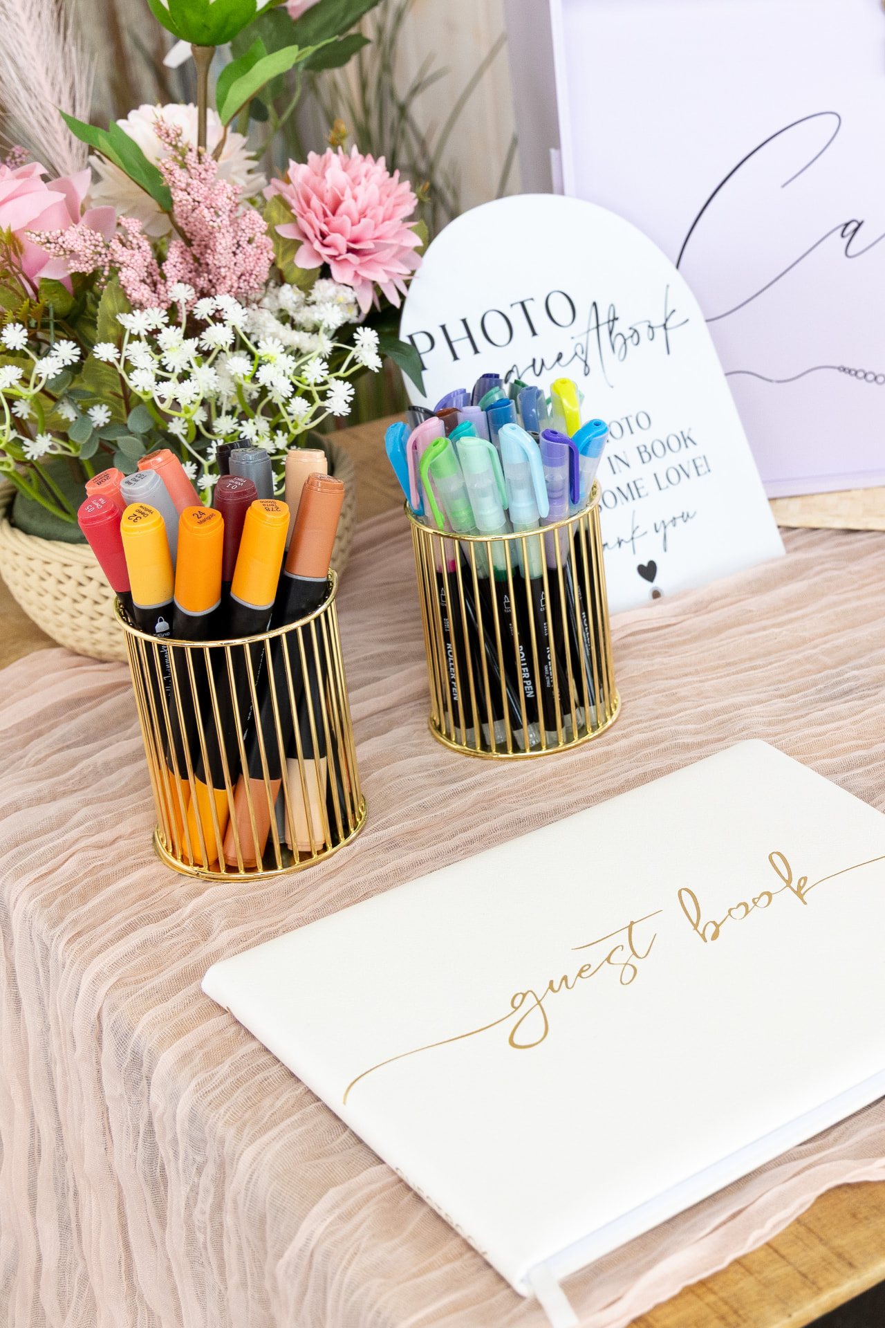 Guest book with gold pen holders and a photo guestbook sign