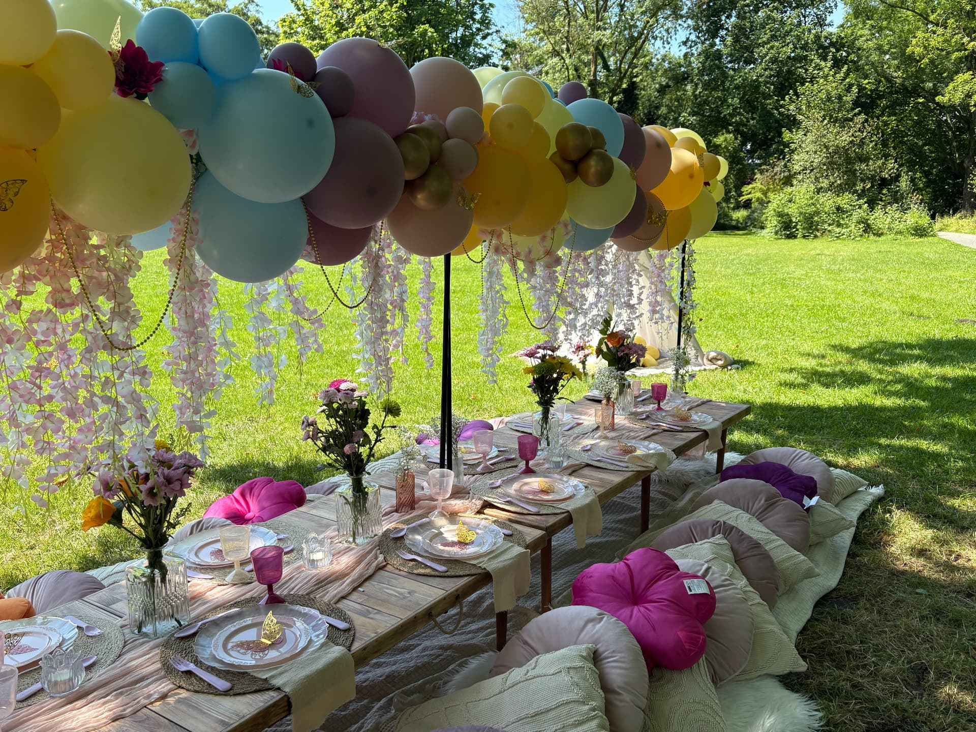 Pastel balloon and picnic styling in a garden