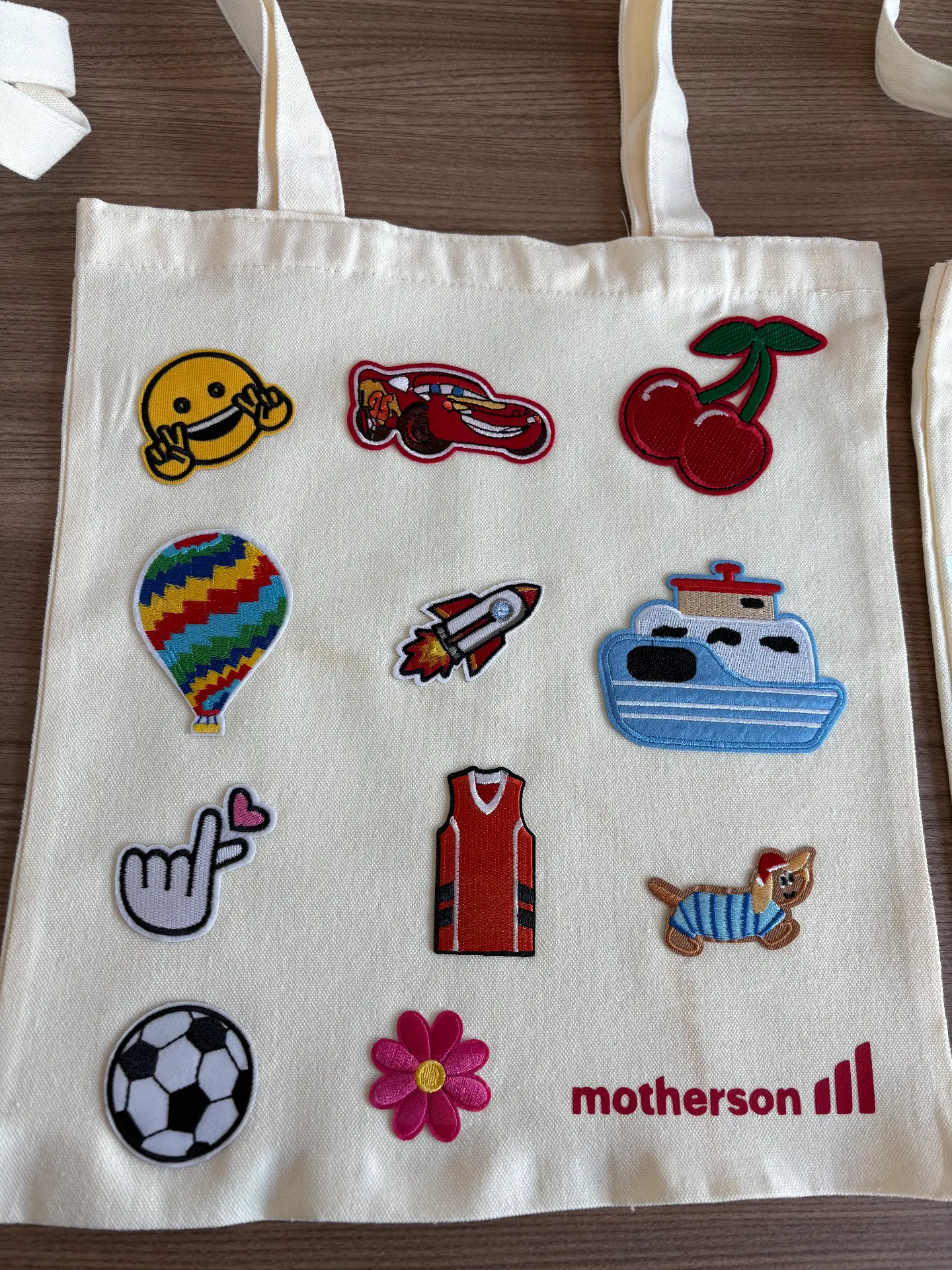 A tote bag decorated with iron-on patches at a Mini Munchkins workshop
