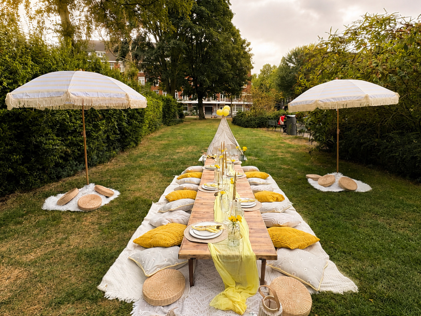 Two styled picnic tables at a yellow garden celebration
