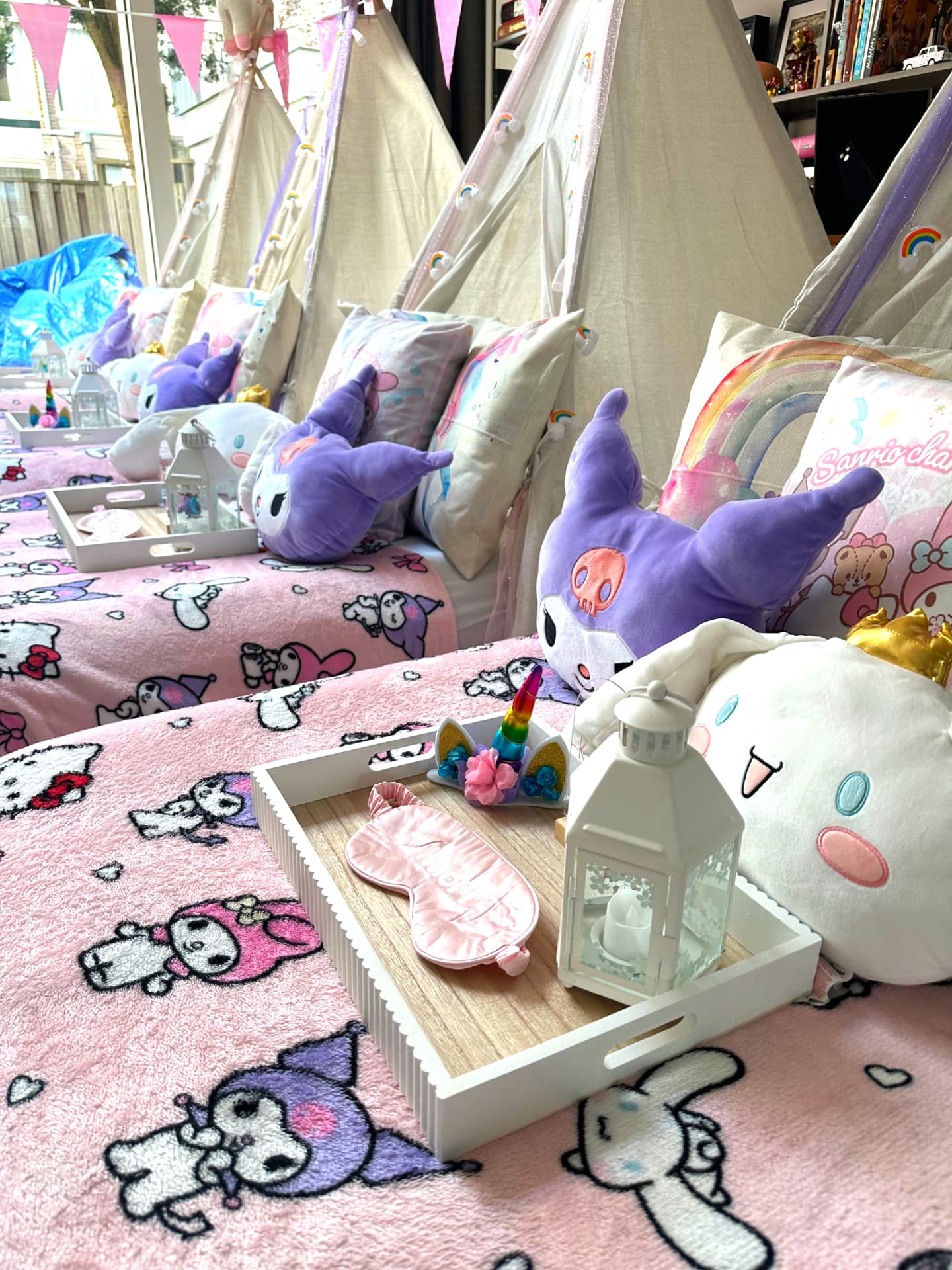 Sleepover bed detail with welcome tray, sleeping mask, lantern and plush friends