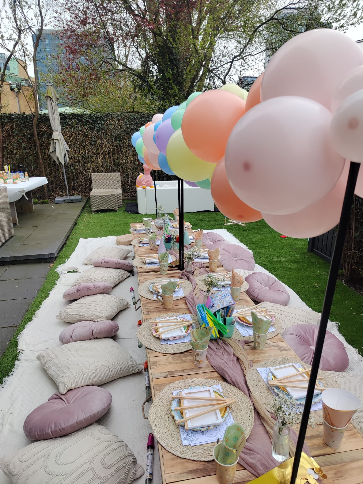 Pastel children’s picnic with balloons and low craft tables