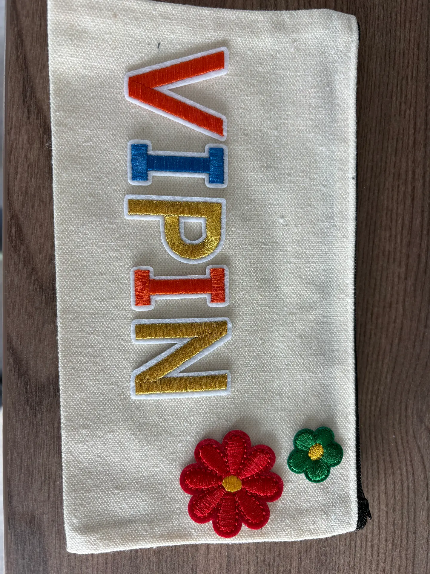 A personalised pouch with letter patches made at a Mini Munchkins workshop